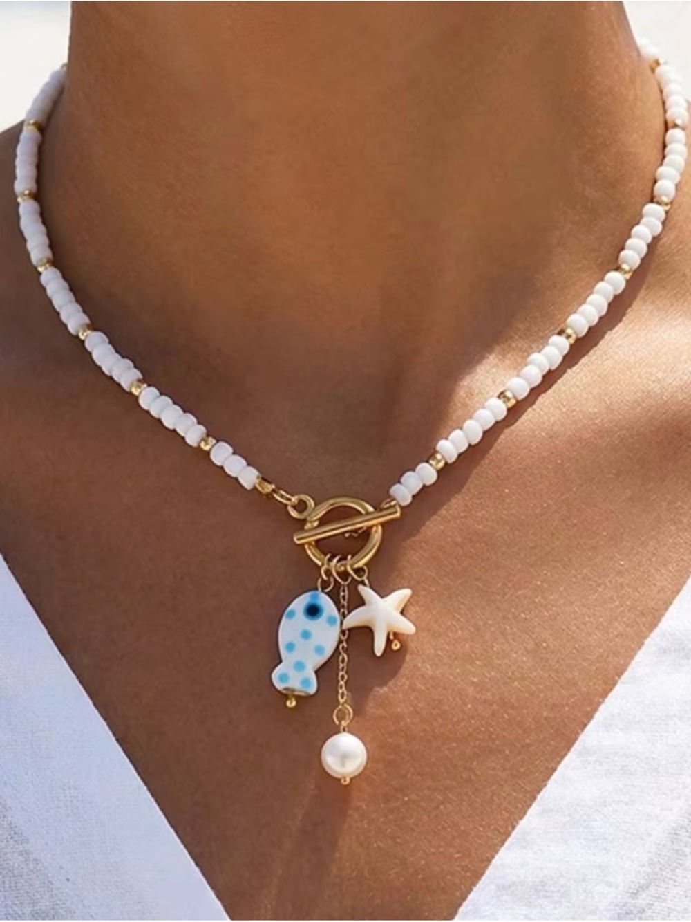 White Beaded Necklace with Gold Toggle and Blue Polka Dot Fish Charm